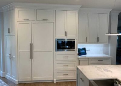 Long white kitchen cabinets by DRW Cabinets