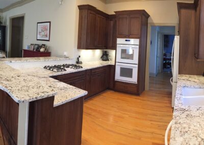 A contemporary kitchen showcasing a large central island and a stylish stove, perfect for cooking and entertaining.