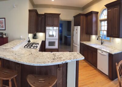 A modern kitchen featuring a spacious island and a sleek stove, designed for functionality and style.